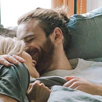 happy couple laying down on the bed