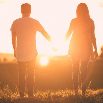 couple holding hands while standing