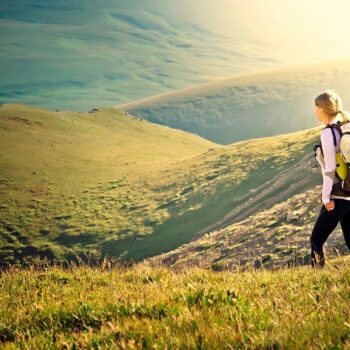 woman hiking down a mountain