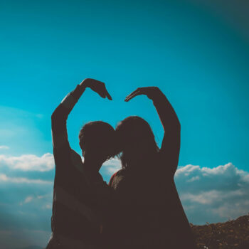 couple's silhouette and a blue sky