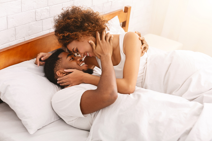 African couple of lovers relaxing in bed at home